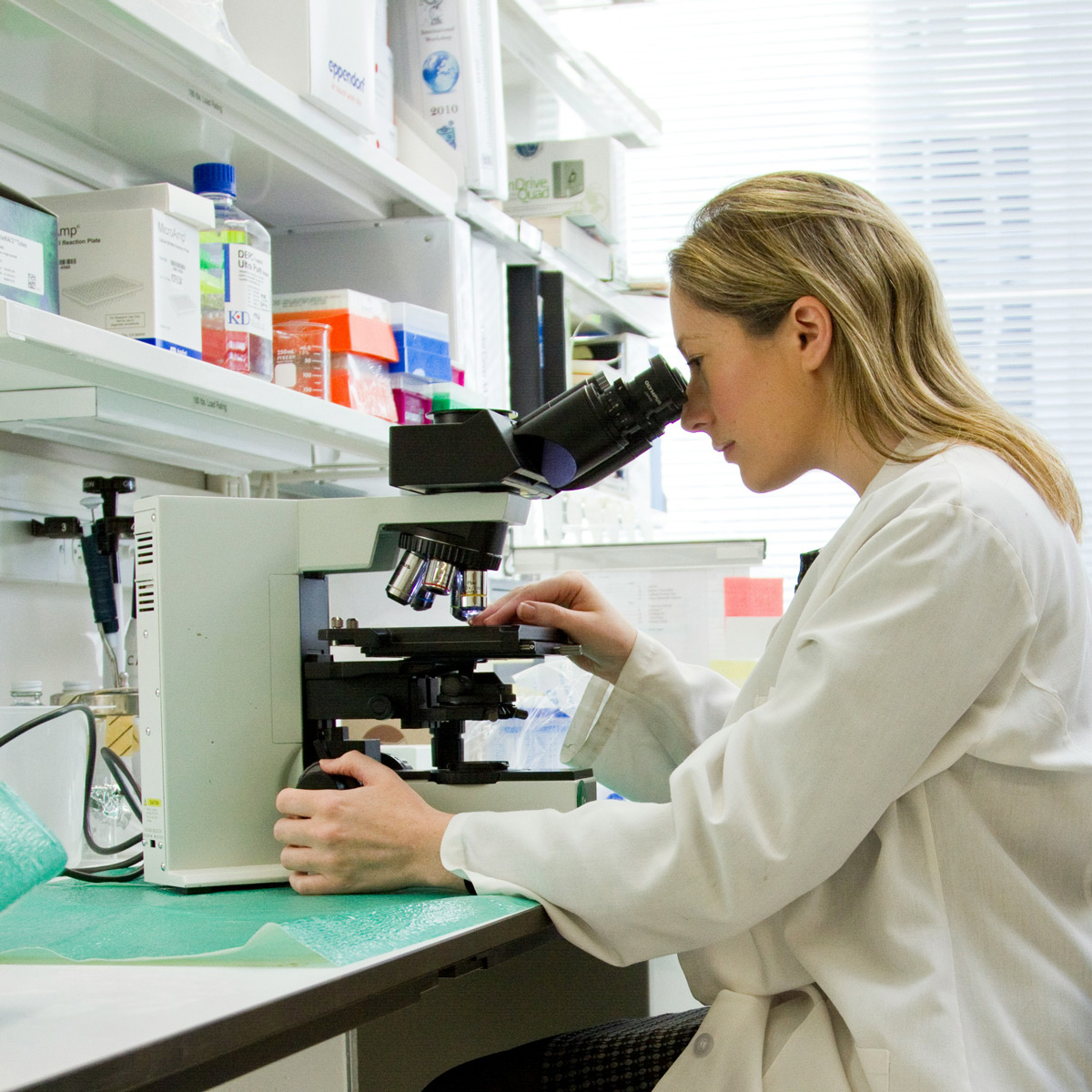 national-cancer-institute-BQGxNnyuFtU-unsplash Researcher at a microscope