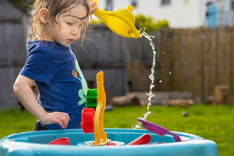 Toddler playing with plastic toys